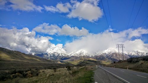 Empty road along countryside landscape