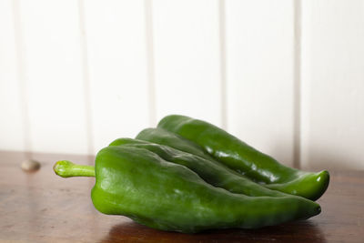 Pair of poblano peppers on a wooden table