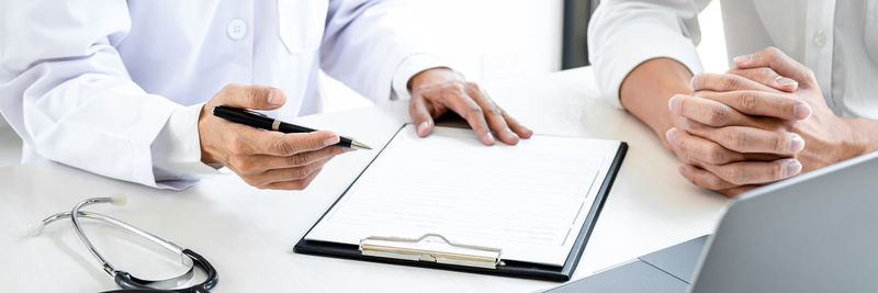 Midsection of doctor working in courtroom