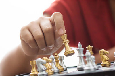 Cropped image of woman playing chess