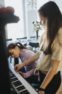 Sisters bonding over playing piano together