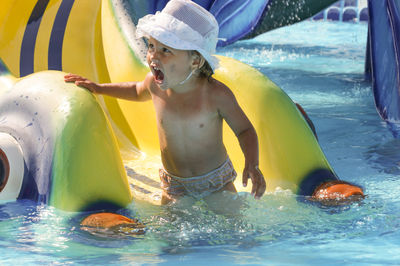 Boy playing in swimming pool