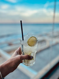 Cropped hand holding drink