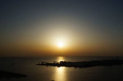 Scenic view of sea against clear sky during sunset