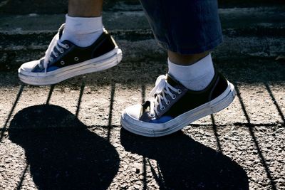 Low section of person walking on street