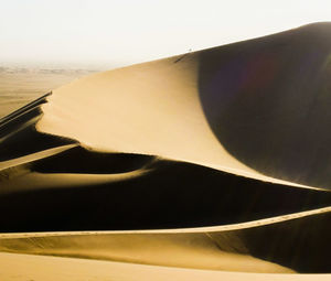 Close-up of sand dune in desert against sky