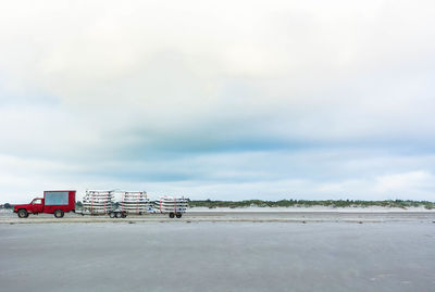 Lifeguard hut at beach against sky