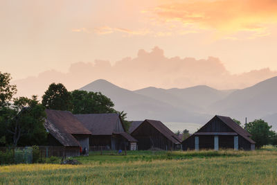 Clearing storm over a rural landscape with a traditional barn.