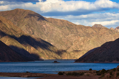 Scenic view of sea and mountains against sky