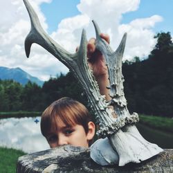 Portrait of boy sculpture against sky