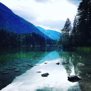 Scenic view of lake and mountains against sky