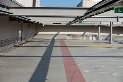 Empty road amidst buildings in city