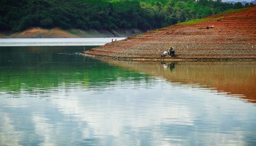 Reflection of man in lake