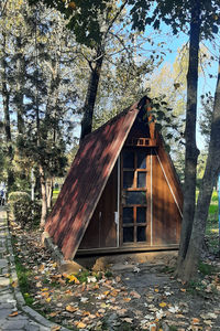 Abandoned building in forest during autumn