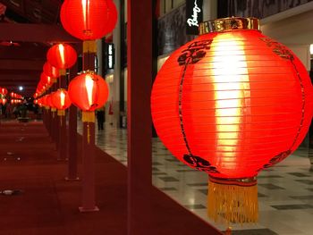 Close-up of illuminated lanterns hanging at night