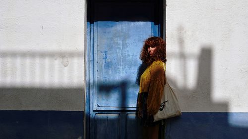 Woman standing by window