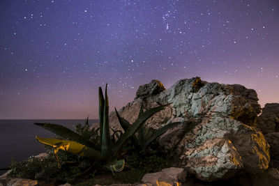 Scenic view of mountains against sky at night