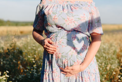 Preganr woman  standing on field