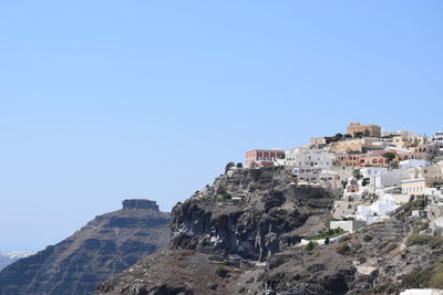 Low angle view of buildings against clear blue sky