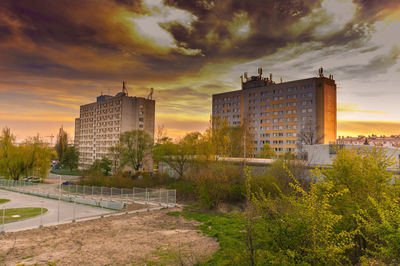 Buildings in city against sky during sunset