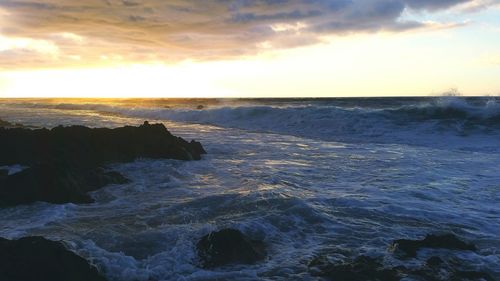 Scenic view of sea against cloudy sky