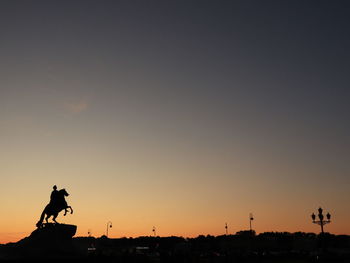 Silhouette horse against sky at sunset