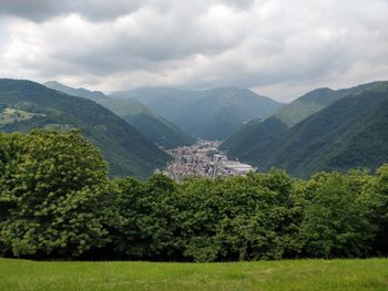 Scenic view of trees and mountains against sky over an italian valley