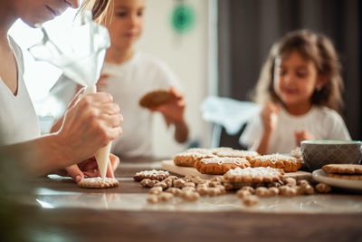 Mother and daughter on table