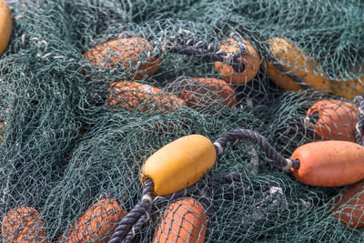 Full frame shot of fishing net and buoys