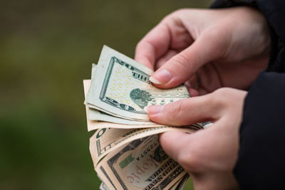 Close-up of hand holding paper