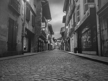 Narrow street amidst buildings in city