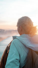 Portrait of woman using mobile phone against sky