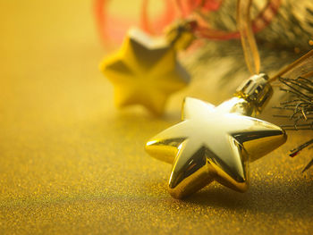 Close-up of christmas ornaments hanging on tree