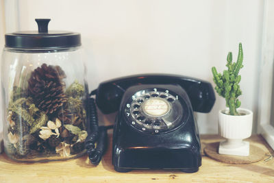 Close-up of landline phone and plants on table