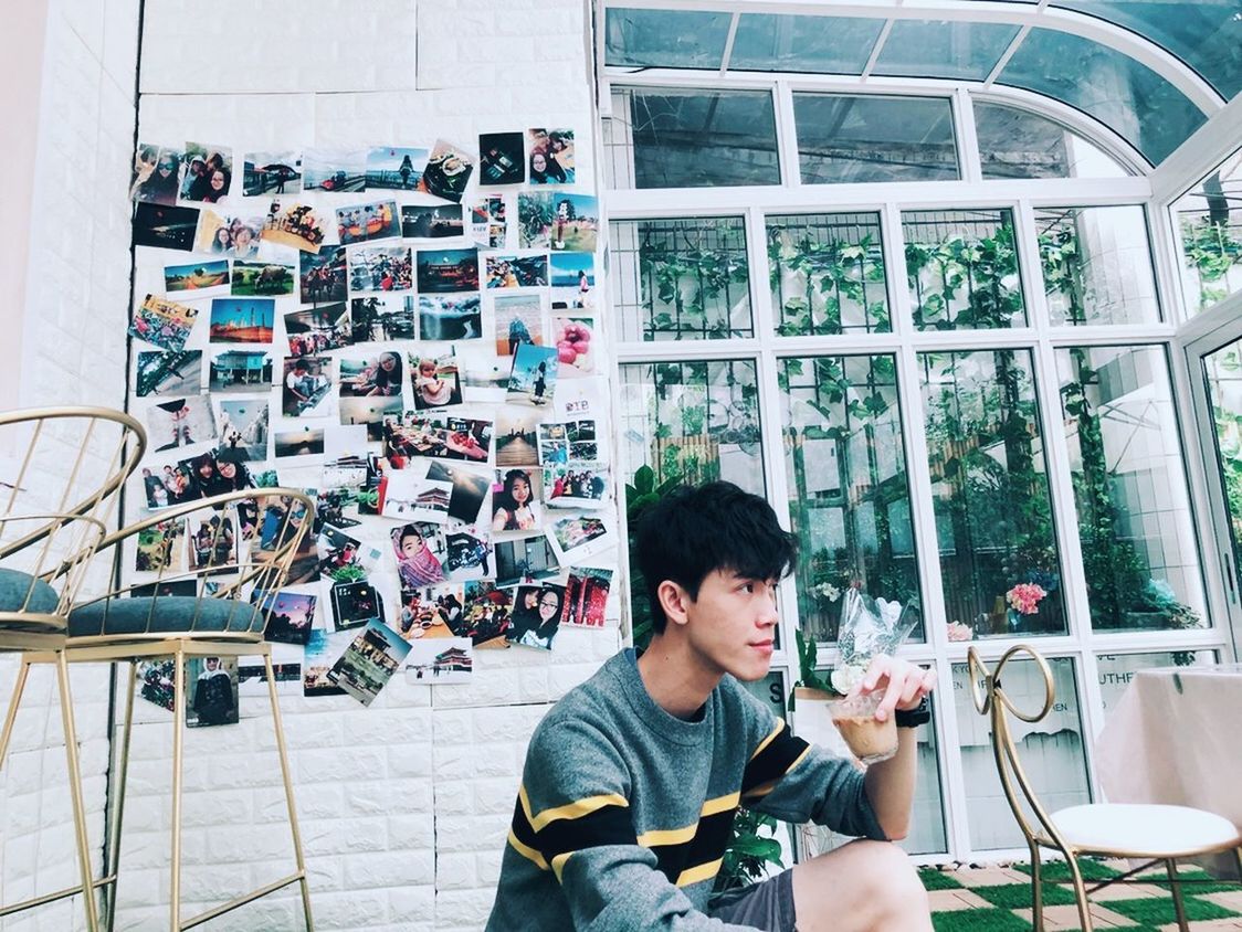 YOUNG MAN LOOKING AT WINDOW