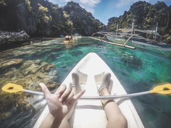 Low section of person on boat in swimming pool