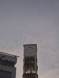 Low angle view of clock tower against sky at dusk