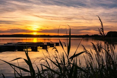 Scenic view of lake against romantic sky at sunset