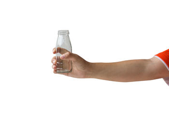 Midsection of person drinking water against white background