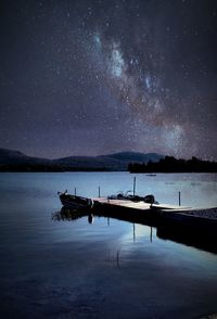 Scenic view of lake against sky at night