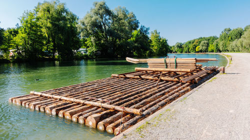 Wooden structure in lake against clear sky