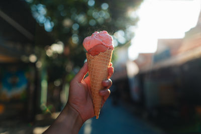 Cropped hand holding ice cream cone