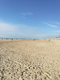 Scenic view of beach against blue sky