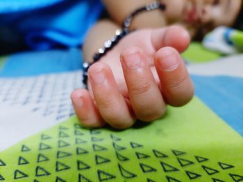 Close-up of woman hand on book