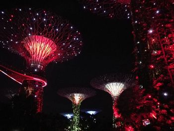 Low angle view of firework display at night