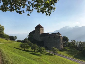 Built structure on landscape against sky