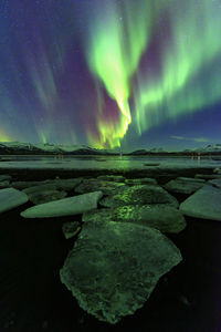 Scenic view of sea against sky at night during winter