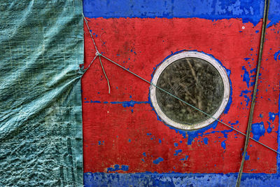 Close-up of porthole on old boat