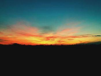 Silhouette landscape against sky at sunset