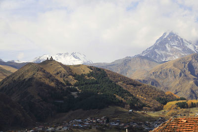 Scenic view of mountains against cloudy sky